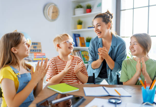istock Happy kids and teacher at school 1410939661