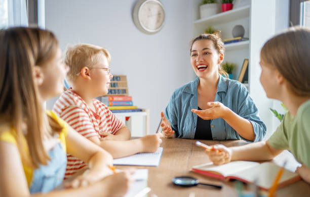istock Happy kids and teacher at school 1410939688