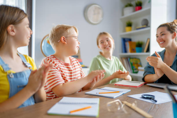 istock Happy kids and teacher at school 1410939697