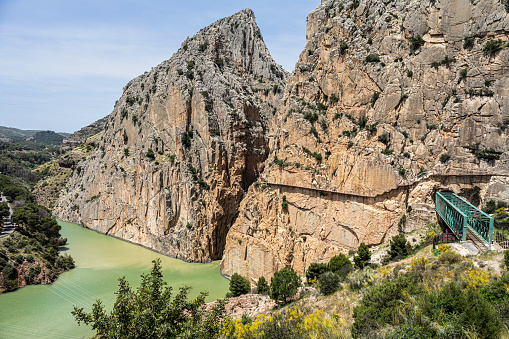 El Caminito del Rey is a walkway pinned along the steep walls of a narrow gorge in El Chorro, near Ardales in the province of Málaga, Spain. The name derives from the original name of Camino del Rey (King's Pathway). The walkway had fallen into disrepair and was partially closed for over a decade. After four years of extensive repairs and renovations, it re-opened in 2015. It has been known in the past as the \