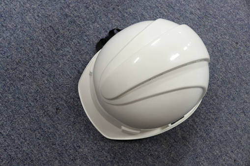 A white safety helmet to protect workers' heads from work accidents, such as collisions with hard objects, helmets are a requirement of safety first