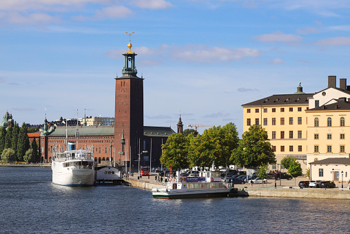 Stockholm, Sweden - August 31, 2021: Waterfront view of the Stockholm City hall and the Riddarholmen.