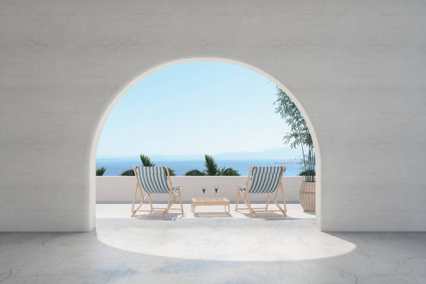 balcony with lounge chairs and seaview through an arch - greece blue house wall imagens e fotografias de stock