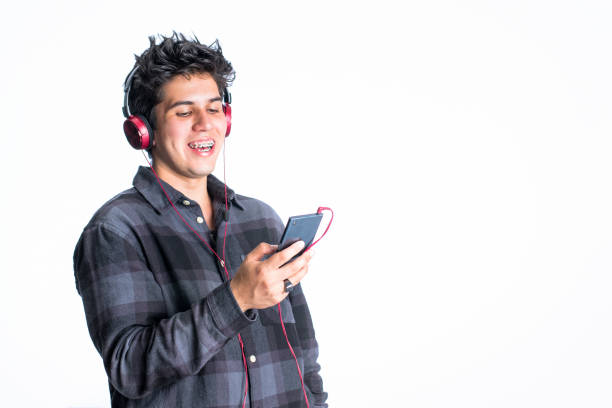 istock Young man with headphones looking at multimedia content on his mobile device 1410946949