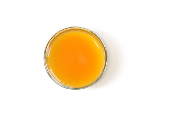 istock orange juice in a glass Vitamin C useful, top view, on white 1410948197
