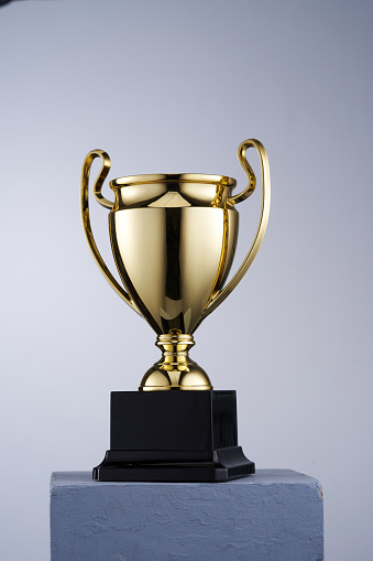gold trophy against white background