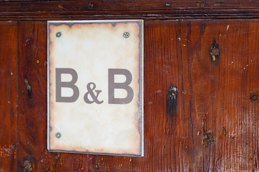 bed and breakfast text on wooden entrance door of b&b hotel building