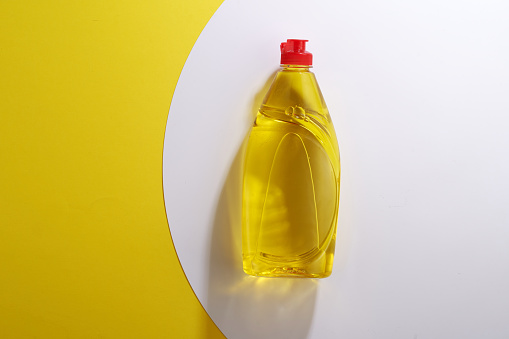 yellow color dishwashing detergent against white and yellow background