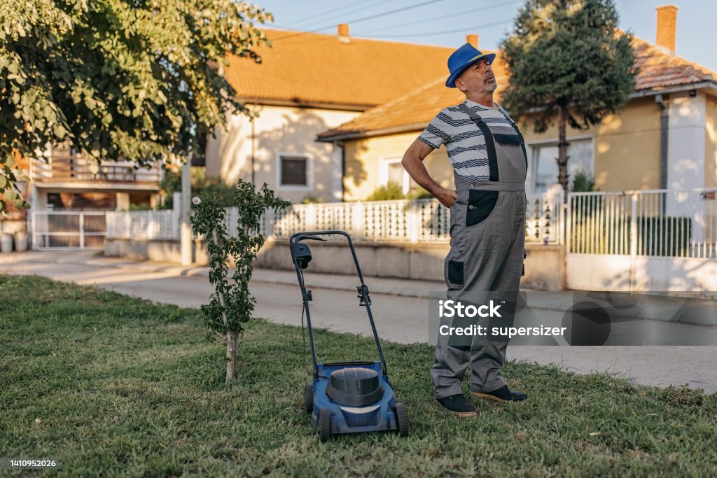 This pain must stop in order to continue Picture of a tired gardener, who has pain in his back. Yard - Grounds Stock Photo