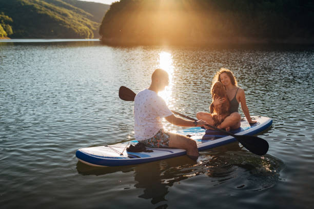 istock During sunset, a loving couple is paddling on a lake 1410953040