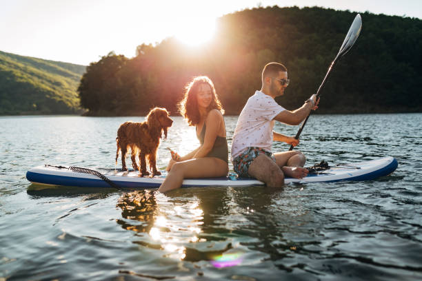 istock A man and his girlfriend use a paddle board to ride on a lake 1410953045