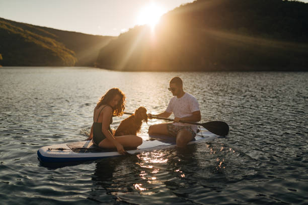 istock Two best friends paddle boarding on the lake 1410953096