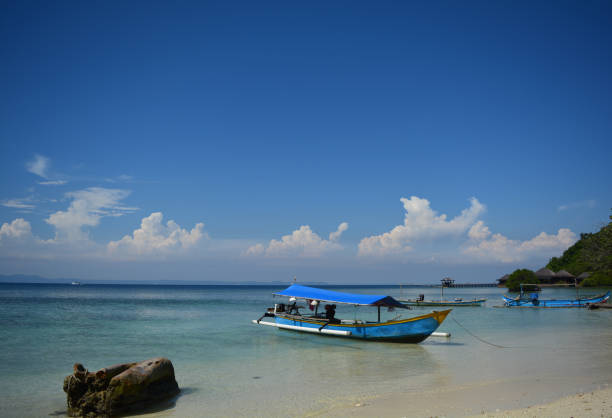istock A simple motorboat is leaning on the beach. 1410955114