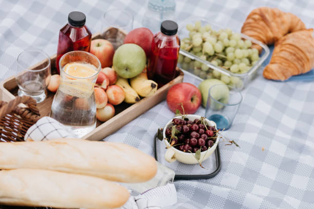 istock Fruits and drinks on the tablecloth at the picnic 1410955288