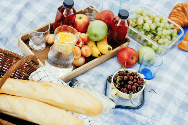 istock Fruits and drinks on the tablecloth at the picnic 1410955293