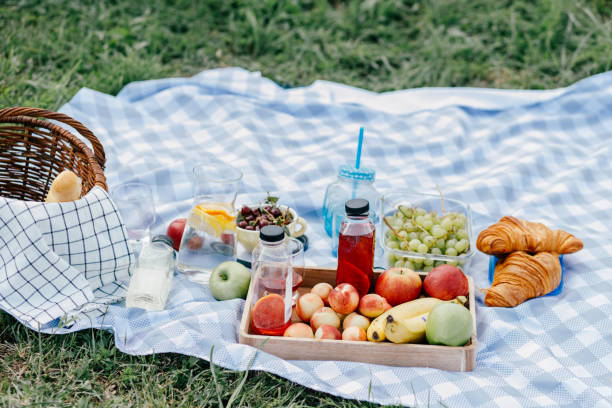 istock Fruits and drinks on the tablecloth at the picnic 1410955315