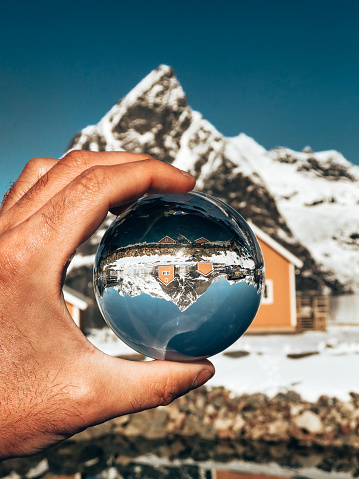 holding a glass sphere in norway