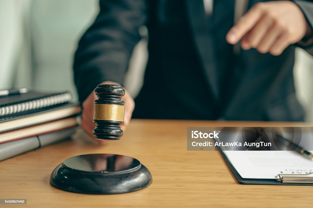 Lawyer who works law at work for a consultant lawyer idea with a hammer put forward. Government Stock Photo
