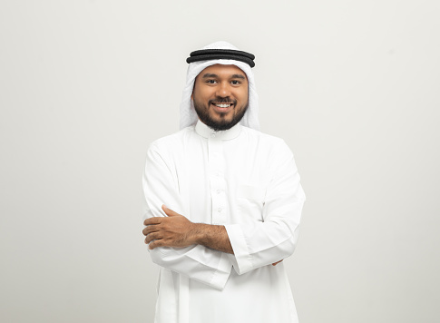 Portrait of arabic man with kandura dress on isolated white background. Arab business people