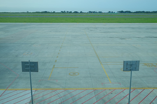 Empty aircraft parking area around the runway complex.