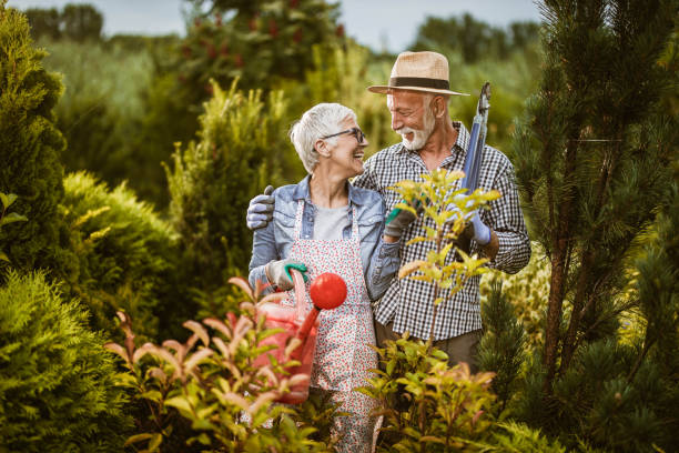 istock Happy senior couple talking while gardening in the back yard. 1410958707
