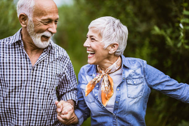 istock Carefree senior couple having fun while running in nature. 1410959325