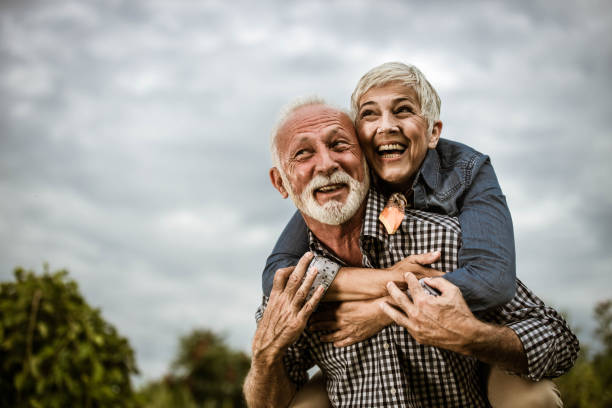 istock Playful senior couple having fun while piggybacking in nature. 1410959676