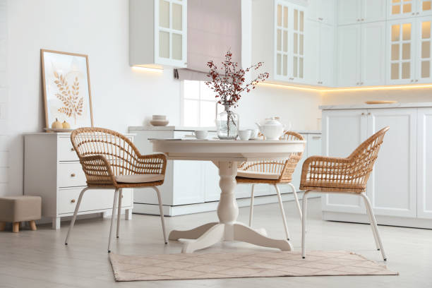 istock Dining room interior with tea set on round table and wicker chairs 1410961011