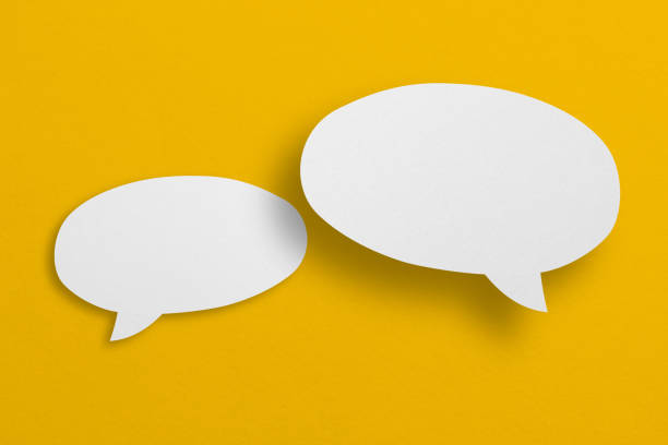istock speech balloon shape white paper isolated on yellow background 1410962239