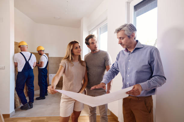 istock Couple working on plans with an architect during home renovation process. 1410962358