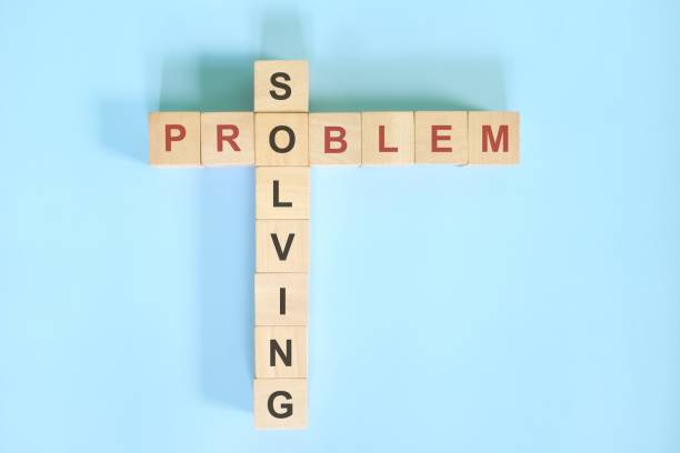 istock Problem solving concept. Wooden block crossword puzzle  flat lay in blue background. 1410962443