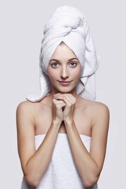 istock Young woman with bath towel on the head 1410964842
