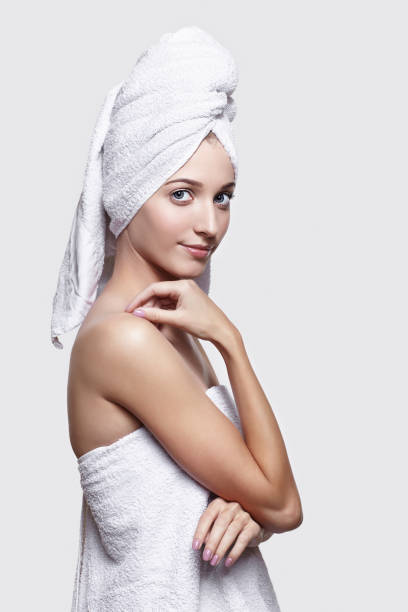 istock Young woman with bath towel on the head 1410964920
