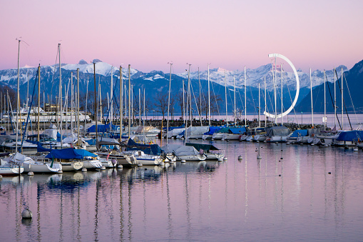 Ouchy marina with Swiss alps in the background during a pink dawn