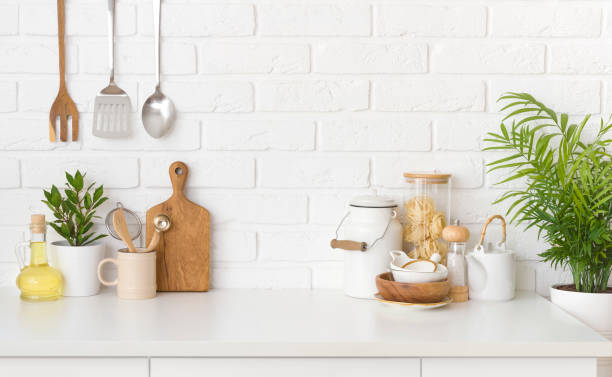 istock Kitchen utensils, cooking ingredients and kitchenware on white counter table 1410966660