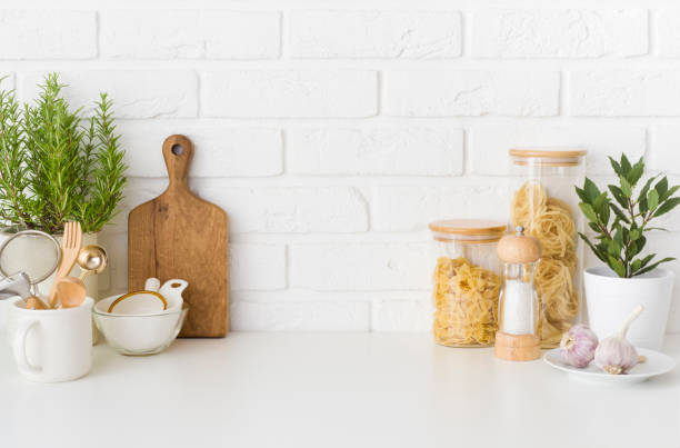 istock Set of pasta ingredients and kitchen utensils on white table 1410966674