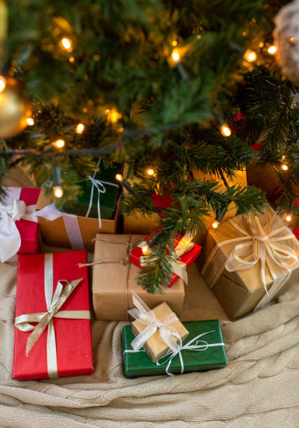 istock gifts under decorated christmas tree at home 1410968764