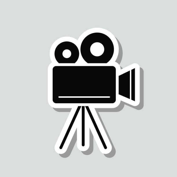 кинокамера со штативом. наклейка на иконку на сером фоне - television camera tripod media equipment videography stock illustrations