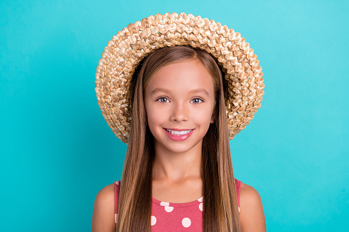 Photo of charming adorable little lady dressed dotted sarafan straw headwear smiling isolated teal color background.