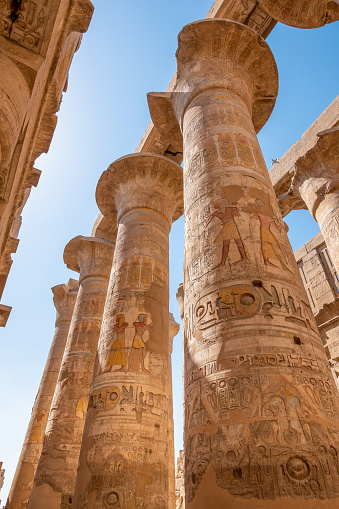 Karnak Temple, Luxor, Egypt - July 26, 2022: The Karnak Temple Complex, commonly known as Karnak  comprises a vast mix of decayed temples, pylons, chapels, and other buildings near Luxor, Egypt. Construction at the complex began during the reign of Senusret I (reigned 1971–1926 BCE) in the Middle Kingdom (around 2000–1700 BCE) and continued into the Ptolemaic Kingdom (305–30 BCE), although most of the extant buildings date from the New Kingdom. \n\nIt is part of the monumental city of Thebes (Luxor), and in 1979 it was inscribed on the UNESCO World Heritage List along with the rest of the city.