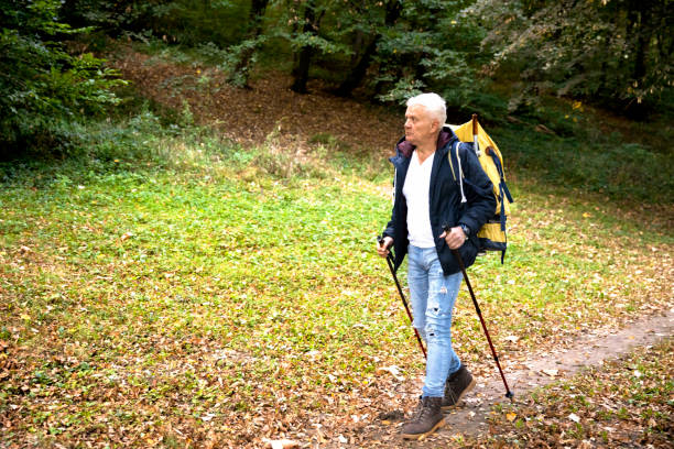 istock Senior men is having fun while hiking stock photo 1410974096