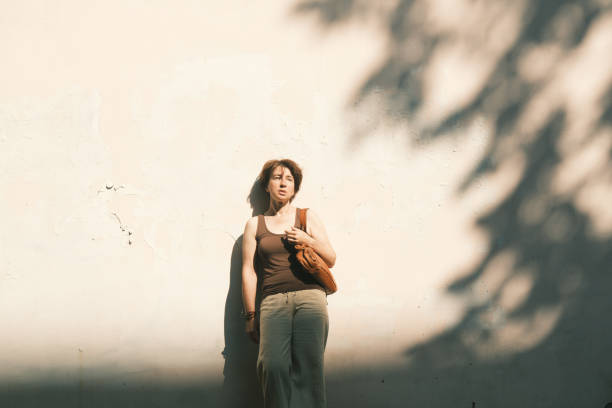 Repair and improvement of the house. a beautiful girl holds wallpaper in her hands, which she is going to stick on the wall with her own hands
