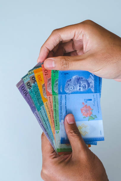 istock Selective focus at money with hand showing Malaysia banknotes, Ringgit Malaysia or Malaysia Ringgit Currency (MYR) 1410976901