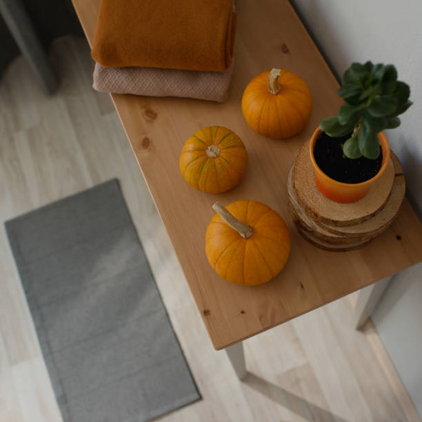 istock Pumpkins in the interior, autumn home decoration on the table 1410978236
