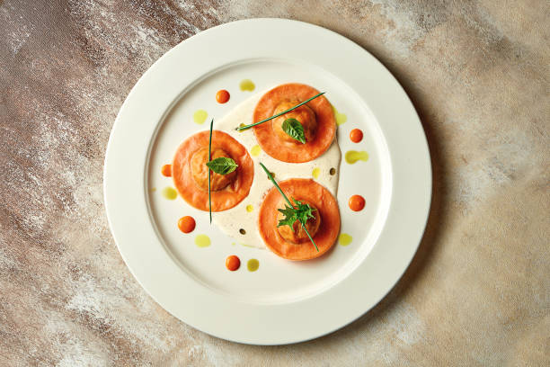 Orange ravioli filled with sauce. Close-up, selective focus