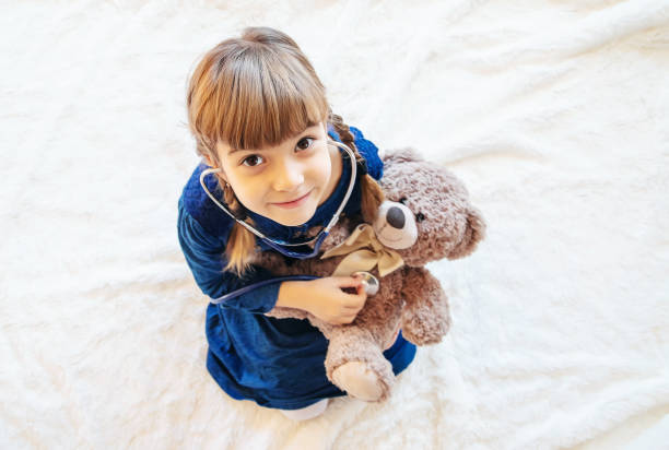 istock Cute Girl With Teddy Bear 1410985039
