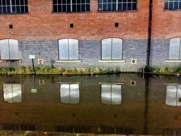Orange, grey, green, charcoal, reflections on the Manchester Rochdale canal