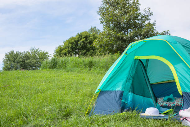 istock Camping tent in meadow,  under blue sky 1410987425