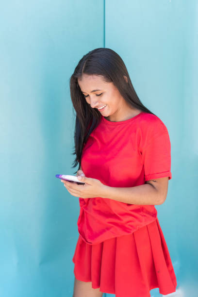 istock Indigenous woman standing on the street while using her cell phone 1410988531