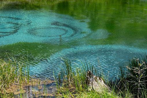 Geyser lake with turquoise thermal springs, close up. Fairytale mountain lake.